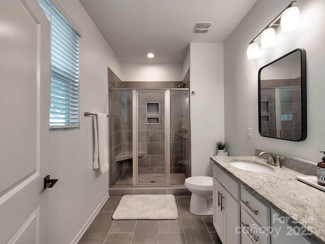 bathroom featuring toilet, vanity, a shower stall, tile patterned flooring, and recessed lighting