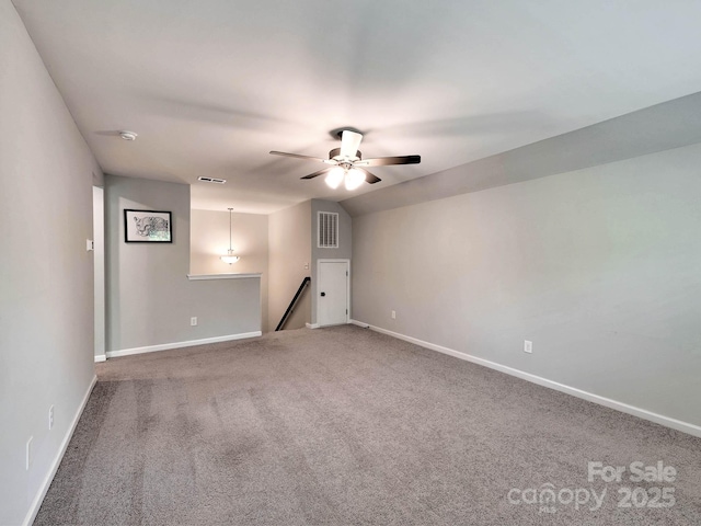 spare room featuring carpet flooring, ceiling fan, and baseboards