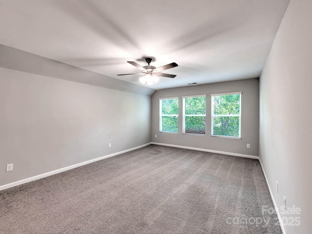 carpeted empty room featuring baseboards and ceiling fan
