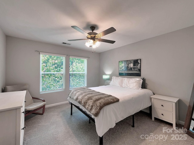 bedroom featuring baseboards, light colored carpet, and ceiling fan