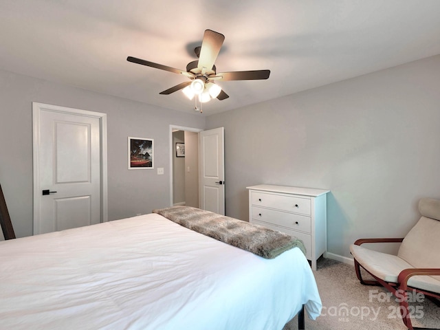 bedroom featuring light colored carpet, baseboards, and ceiling fan