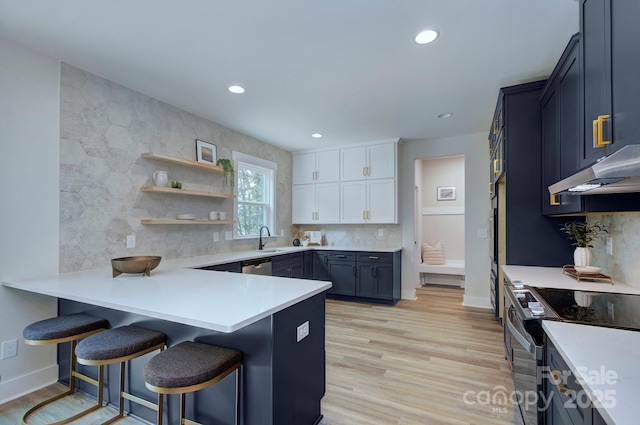 1025 Harrogate Dr, Bessemer City, NC 28016 - kitchen with electric range oven, under cabinet range hood, a kitchen breakfast bar, baseboards, and recessed lighting