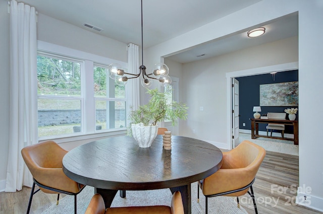 1025 Harrogate Dr, Bessemer City, NC 28016 - dining room with a chandelier, light wood-type flooring, and healthy amount of natural light