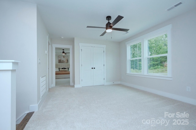 1025 Harrogate Dr, Bessemer City, NC 28016 - unfurnished bedroom with carpet, baseboards, a closet, and a ceiling fan