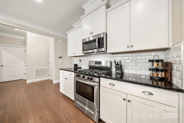 274 Robinwood Ln, Lake Wylie, SC 29710 - kitchen with stainless steel appliances, dark wood finished floors, ornamental molding, white cabinetry, and backsplash