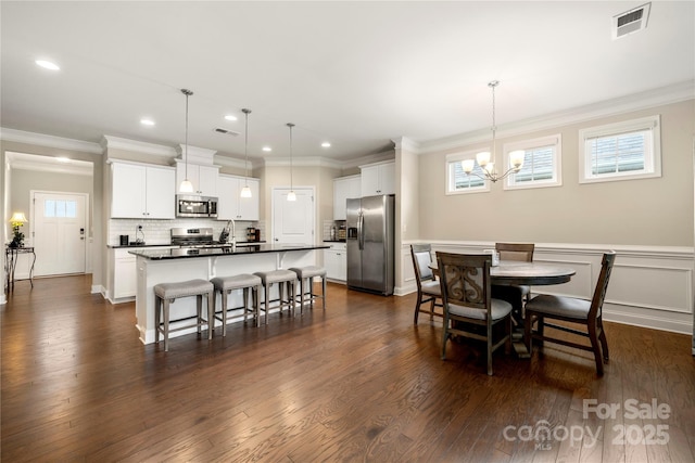 274 Robinwood Ln, Lake Wylie, SC 29710 - dining room with a chandelier, recessed lighting, dark wood-style flooring, and crown molding