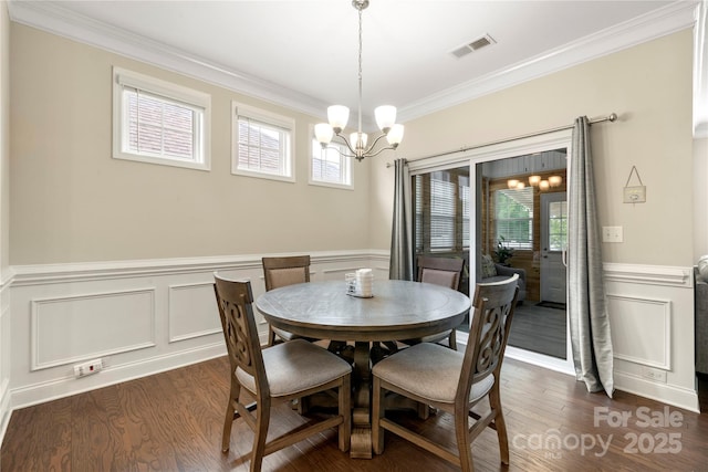 274 Robinwood Ln, Lake Wylie, SC 29710 - dining space featuring a chandelier, ornamental molding, wainscoting, a decorative wall, and plenty of natural light