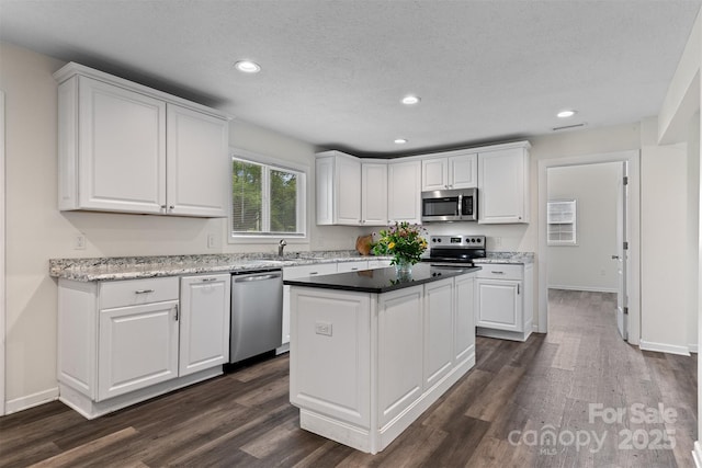 25 Southern Way, Nebo, NC 28761 - kitchen featuring appliances with stainless steel finishes, white cabinets, a sink, recessed lighting, and a textured ceiling