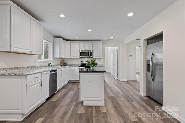 25 Southern Way, Nebo, NC 28761 - kitchen featuring appliances with stainless steel finishes, a center island, white cabinetry, recessed lighting, and wood finished floors