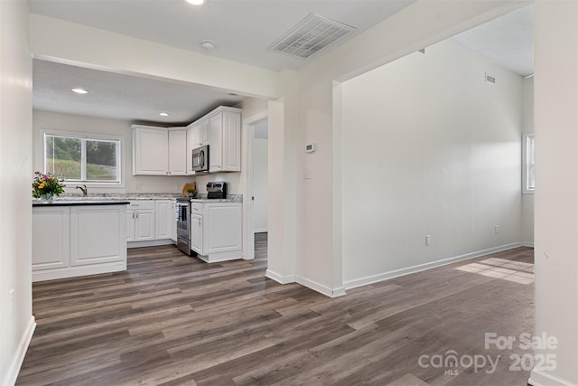 25 Southern Way, Nebo, NC 28761 - kitchen with stainless steel appliances, dark wood-style flooring, white cabinets, baseboards, and recessed lighting