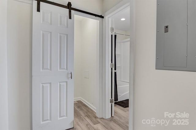 25 Southern Way, Nebo, NC 28761 - hall featuring electric panel, light wood-style flooring, a barn door, and baseboards