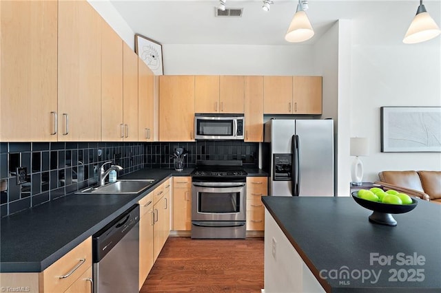 810 W 4th St Unit 201, Winston Salem, NC 27101 - kitchen with appliances with stainless steel finishes, light brown cabinets, dark countertops, and a sink