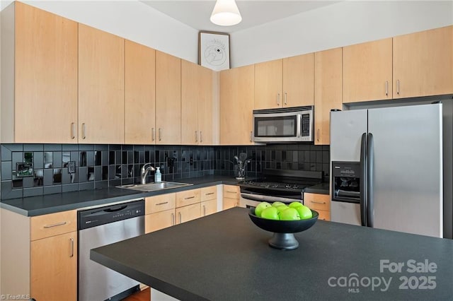 810 W 4th St Unit 201, Winston Salem, NC 27101 - kitchen with appliances with stainless steel finishes, a sink, light brown cabinets, dark countertops, and decorative backsplash