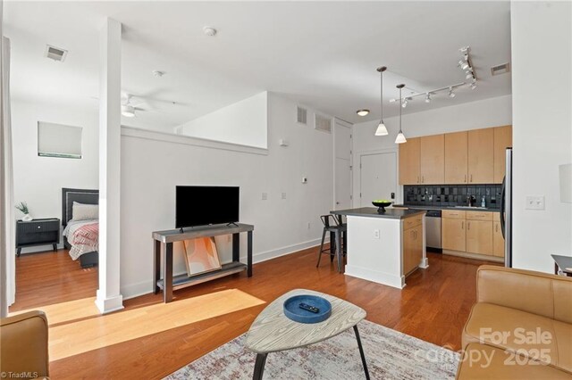 810 W 4th St Unit 201, Winston Salem, NC 27101 - living area featuring wood finished floors, ceiling fan, and baseboards