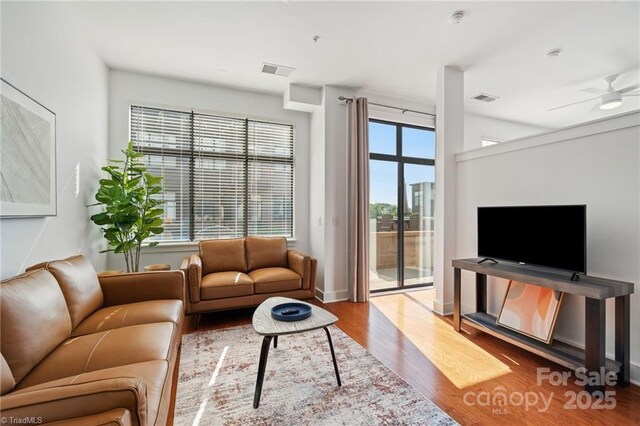 810 W 4th St Unit 201, Winston Salem, NC 27101 - living area featuring wood finished floors, baseboards, and a ceiling fan
