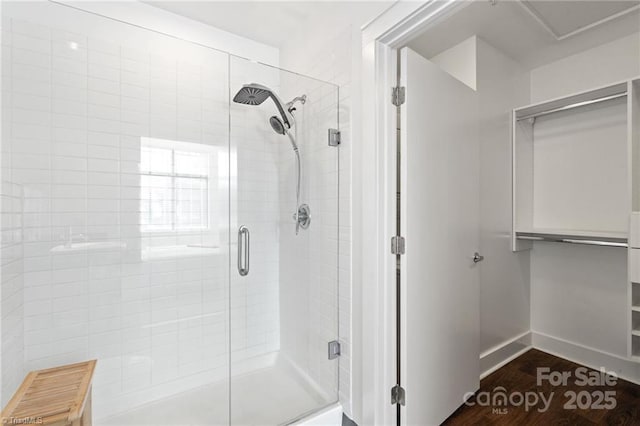 810 W 4th St Unit 201, Winston Salem, NC 27101 - full bathroom featuring a stall shower, baseboards, and wood finished floors