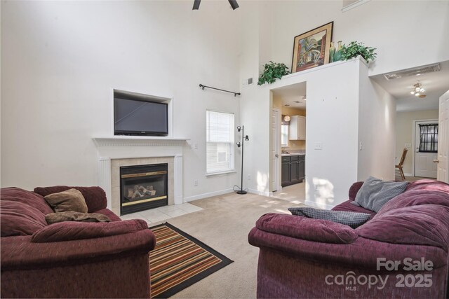 1457 Matthew Allen Cir, Kannapolis, NC 28081 - living room with light colored carpet, a fireplace, a towering ceiling, baseboards, and healthy amount of natural light