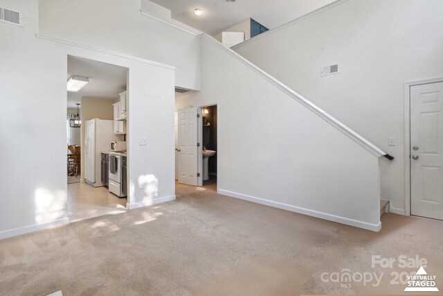 1457 Matthew Allen Cir, Kannapolis, NC 28081 - unfurnished living room with light colored carpet, stairway, and baseboards