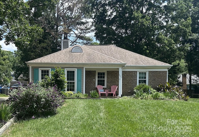 7607 Swedish Ivy Ln, Charlotte, NC 28227 - back of property with a lawn, a chimney, brick siding, and a shingled roof
