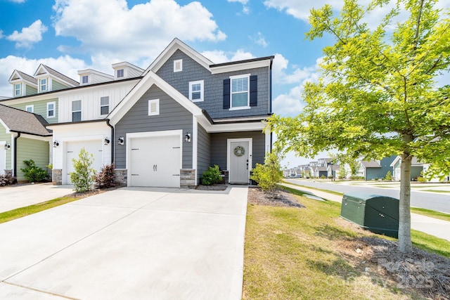 711 Bellmouth Rd, Clover, SC 29710 - view of front of home with board and batten siding, driveway, stone siding, and an attached garage