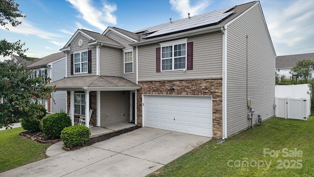 8511 Redding Glen Ave, Charlotte, NC 28216 - traditional-style home with a porch, stone siding, an attached garage, roof mounted solar panels, and driveway
