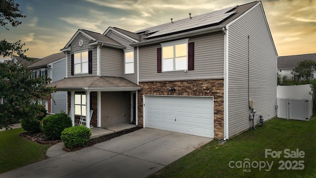 8511 Redding Glen Ave, Charlotte, NC 28216 - traditional home featuring covered porch, a garage, stone siding, solar panels, and concrete driveway