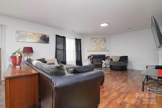 8511 Redding Glen Ave, Charlotte, NC 28216 - living room featuring a glass covered fireplace and wood finished floors