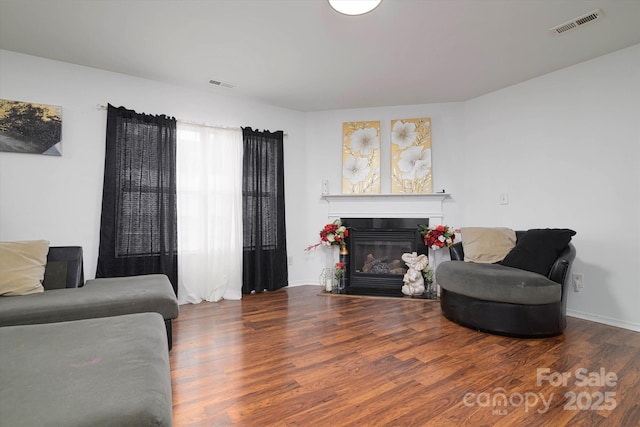 8511 Redding Glen Ave, Charlotte, NC 28216 - living area featuring wood finished floors, a glass covered fireplace, and baseboards