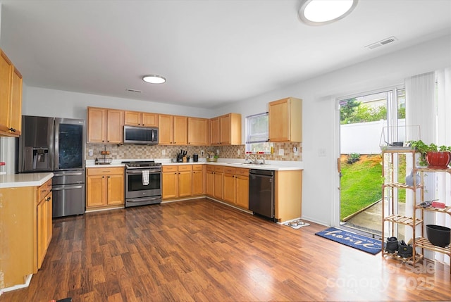 8511 Redding Glen Ave, Charlotte, NC 28216 - kitchen with appliances with stainless steel finishes, dark wood-style floors, light countertops, and tasteful backsplash