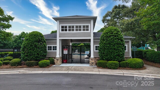 8511 Redding Glen Ave, Charlotte, NC 28216 - view of front of house with fence, roof with shingles, and a gate