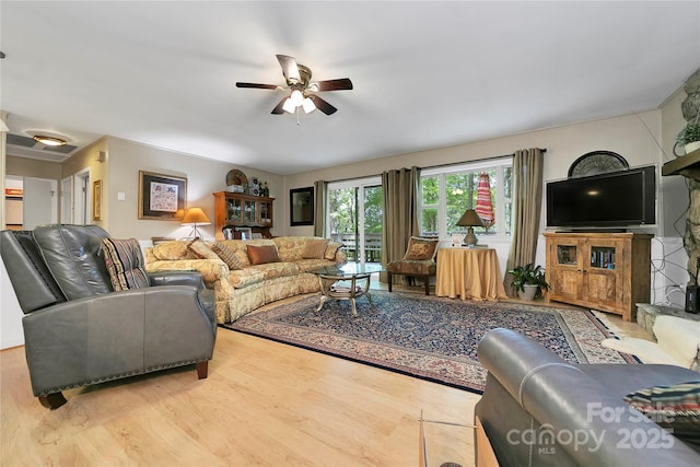 living room featuring a ceiling fan and wood finished floors