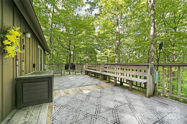 wooden terrace with view of scattered trees