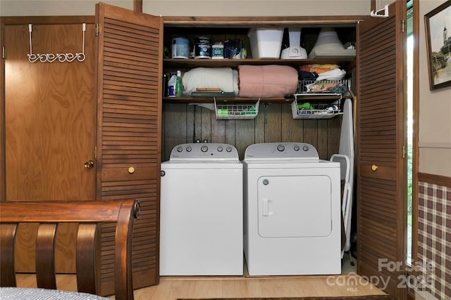 laundry area featuring independent washer and dryer and wood finished floors