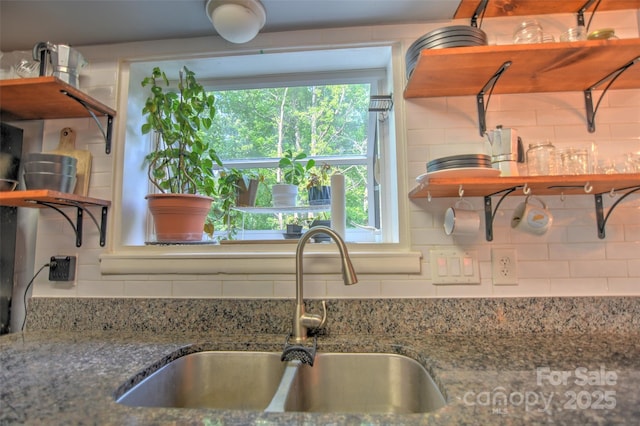 5995 Tall Tree Ln, Harrisburg, NC 28075 - kitchen with a sink, open shelves, backsplash, and stone countertops
