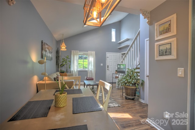 5995 Tall Tree Ln, Harrisburg, NC 28075 - dining space with stairs, high vaulted ceiling, plenty of natural light, wood finished floors, and a chandelier