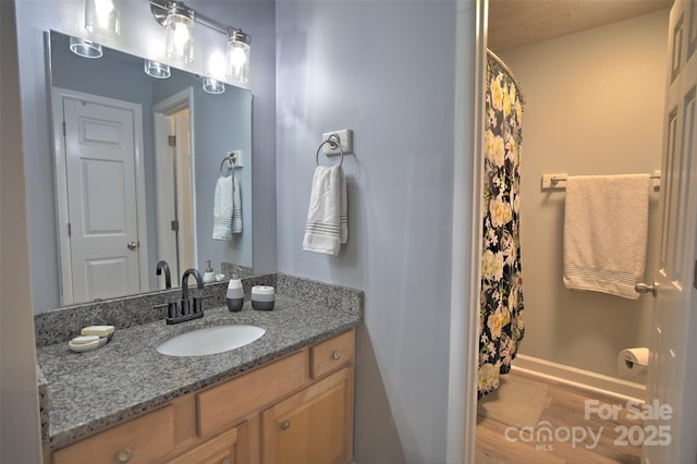 5995 Tall Tree Ln, Harrisburg, NC 28075 - bathroom featuring wood finished floors, vanity, baseboards, and curtained shower