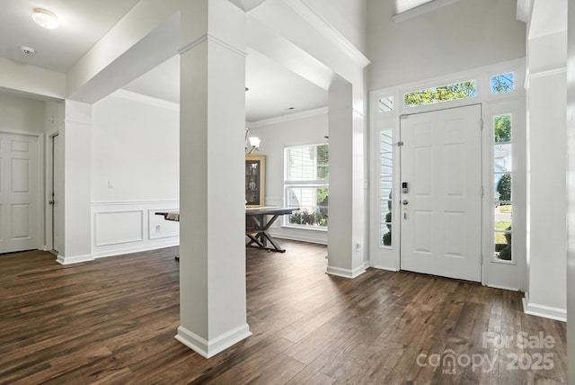 2426 Tory Oak Pl, Matthews, NC 28105 - entryway with dark wood finished floors, ornate columns, ornamental molding, and a chandelier
