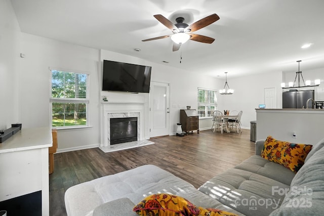 2426 Tory Oak Pl, Matthews, NC 28105 - living room featuring a chandelier, ceiling fan, wood finished floors, and a fireplace