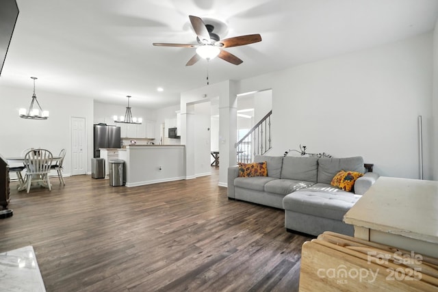 2426 Tory Oak Pl, Matthews, NC 28105 - living room featuring a chandelier, a ceiling fan, dark wood-style floors, and stairs