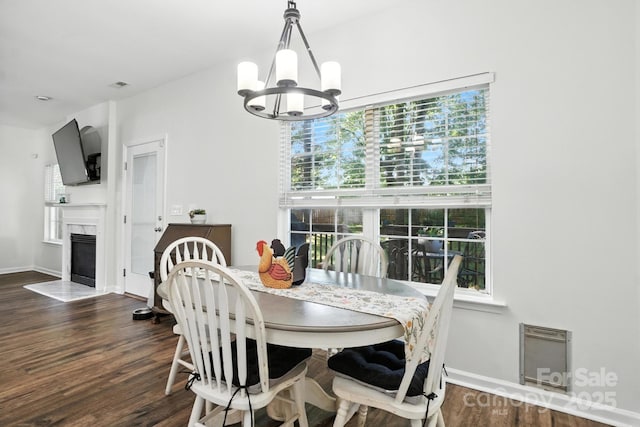 2426 Tory Oak Pl, Matthews, NC 28105 - dining room featuring a chandelier, dark wood finished floors, a high end fireplace, and heating unit