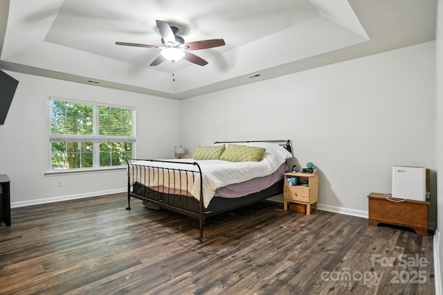 2426 Tory Oak Pl, Matthews, NC 28105 - bedroom featuring a tray ceiling, wood finished floors, and ceiling fan
