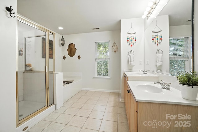 2426 Tory Oak Pl, Matthews, NC 28105 - full bathroom featuring plenty of natural light, double vanity, a garden tub, and a stall shower