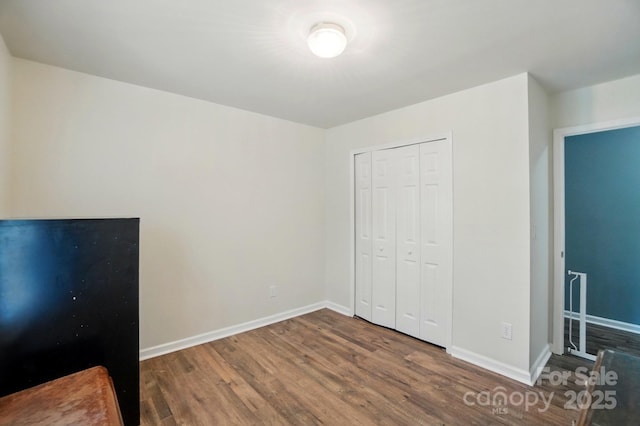 2426 Tory Oak Pl, Matthews, NC 28105 - unfurnished bedroom with wood finished floors and a closet