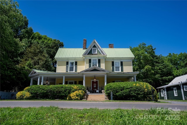 131 E Lexington Rd, Mocksville, NC 27028 - view of front of property with a chimney, covered porch, and metal roof