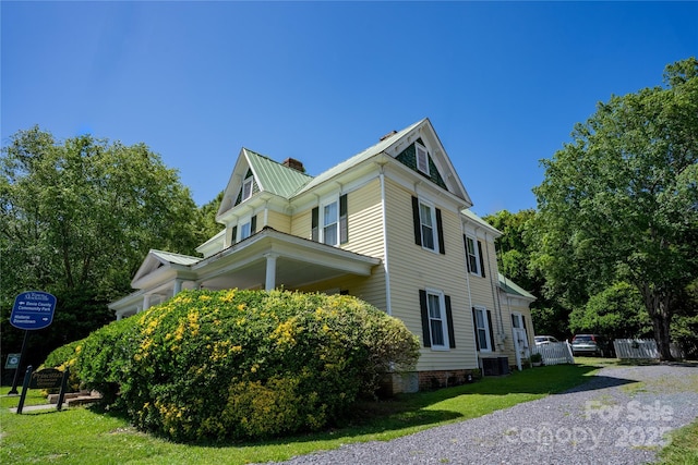 131 E Lexington Rd, Mocksville, NC 27028 - view of home's exterior with a chimney, a yard, and central air condition unit