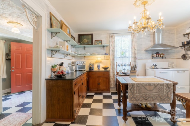 131 E Lexington Rd, Mocksville, NC 27028 - kitchen featuring tile patterned floors, wall chimney range hood, a chandelier, dark countertops, and ornamental molding
