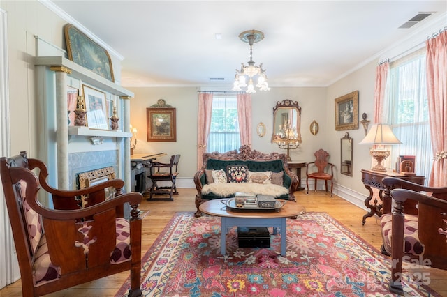 131 E Lexington Rd, Mocksville, NC 27028 - living area with a chandelier, crown molding, light wood finished floors, and baseboards