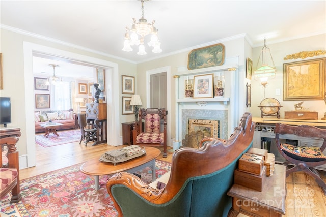 131 E Lexington Rd, Mocksville, NC 27028 - living area with a chandelier, wood finished floors, crown molding, and a glass covered fireplace