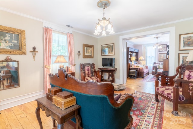 131 E Lexington Rd, Mocksville, NC 27028 - living room featuring a chandelier, healthy amount of natural light, crown molding, and hardwood / wood-style floors