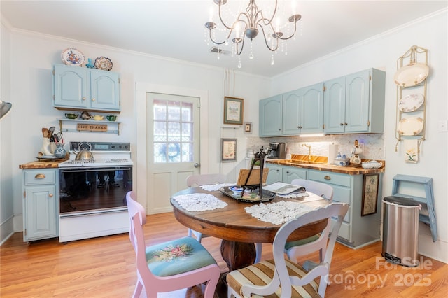 131 E Lexington Rd, Mocksville, NC 27028 - dining area with light wood-style flooring, a chandelier, and crown molding